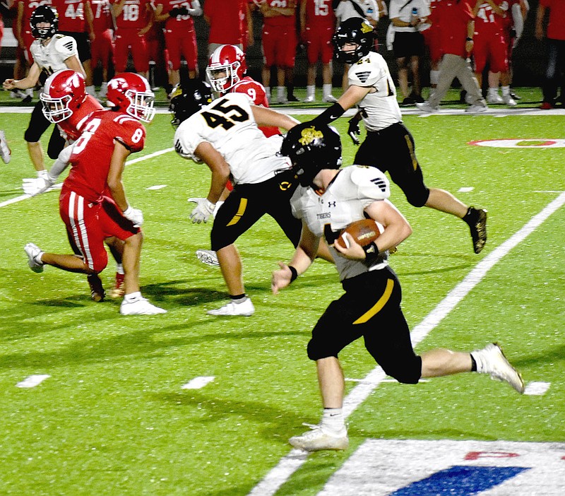 MARK HUMPHREY  ENTERPRISE-LEADER/Prairie Grove senior Coner Whetsell takes the football 83 yards for a touchdown during the third quarter of Friday's 'Battle of 62.' Whetsell also ran 77 yards for a touchdown in the first quarter but the Tigers lost 56-27 to Farmington.