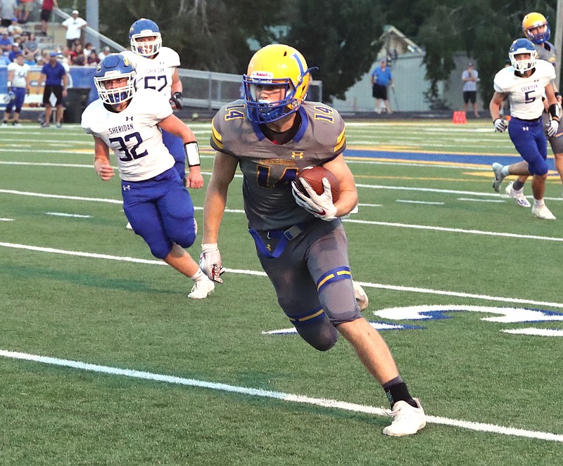 Lakeside sophomore Skylar Purifoy rushes with the ball early in Friday's game against Sheridan. The Yellowjackets defeated the Rams 24-7. - Photo by Richard Rasmussen of The Sentinel-Record