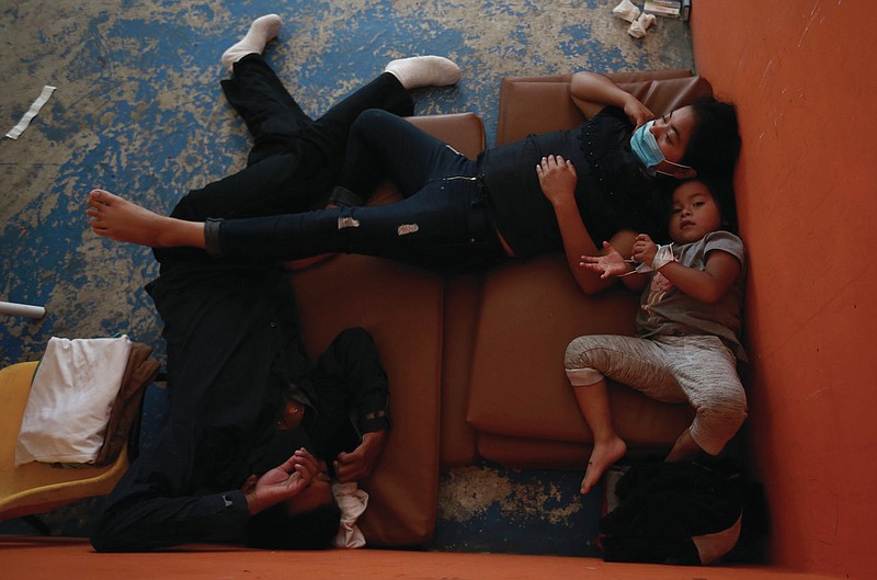 Guatemalan migrants who were expelled from the United States, sit in isolation after testing positive for COVID-19, in a shelter in Ciudad Juarez, Mexico, Saturday, Sept. 4, 2021. More photos at arkansasonline.com/95covid19/.
 (AP Photo/Christian Chavez)