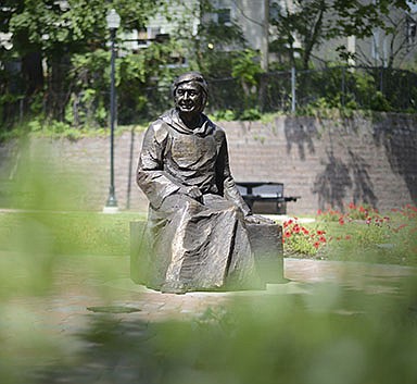 FILE - This July 28, 2015 file photo shows a statue of Father Mychal Judge in a small park in East Rutherford, N.J. Judge, a Catholic chaplain with New York&#x2019;s fire department, left a uniquely complex legacy that continues to evolve 20 years after his death. (Carmine Galasso/The Record via AP, File)