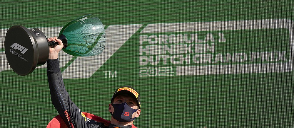 Red Bull driver Max Verstappen of the Netherlands celebrates on the podium after winning the Formula One Dutch Grand Prix, at the Zandvoort racetrack, Netherlands, Sunday, Sept. 5, 2021. (AP Photo/Francisco Seco)