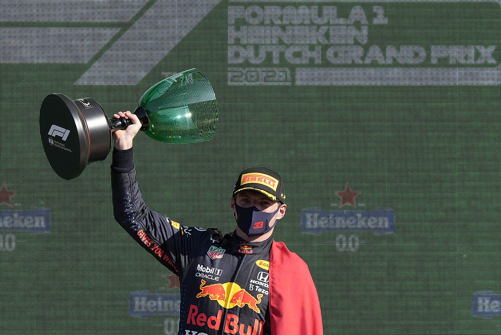 Red Bull driver Max Verstappen of the Netherlands celebrates on the podium after winning the Formula One Dutch Grand Prix, at the Zandvoort racetrack, Netherlands, Sunday, Sept. 5, 2021. (AP Photo/Peter Dejong)