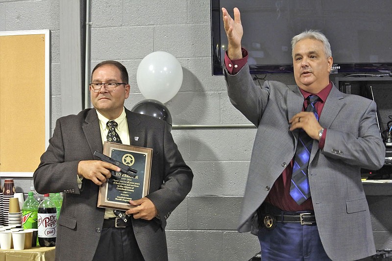 Jim Damante, the new sheriff of Crawford County, right, speaks while outgoing Sheriff Ron Brown, left, listens during the retirement party for Brown at the Crawford County Emergency Operations Center in Van Buren Tuesday. 
(NWA Democrat-Gazette/Thomas Saccente)