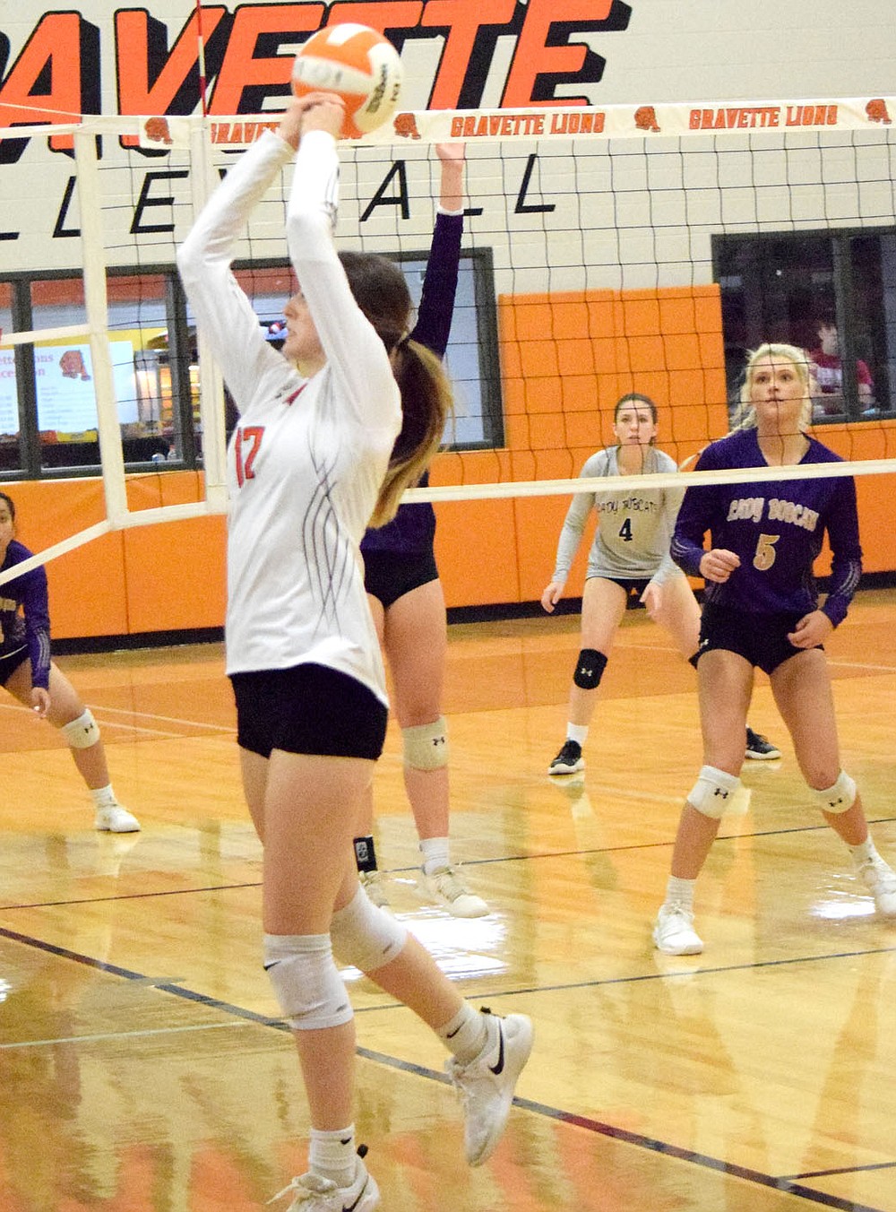 Westside Eagle Observer/MIKE ECKELS
Jayden Reams (12) manages to keep the ball in play as it heads out of bounds during the third set of the Gravette-Berryville volleyball match at the Competition Gym in Gravette Thursday night.