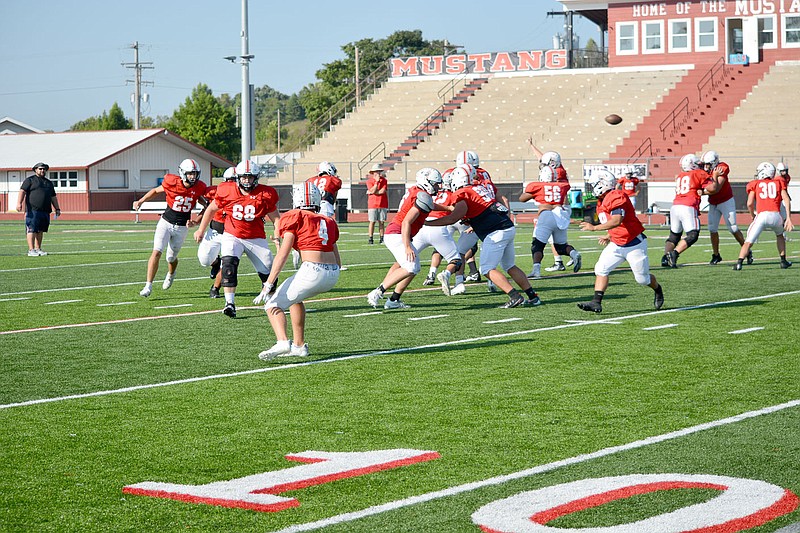 Al Gaspeny/Special to McDonald County Press
A Cole Martin pass sails over defenders during Tuesday's practice at Mustang Stadium. McDonald County is the last team to defeat Lamar.