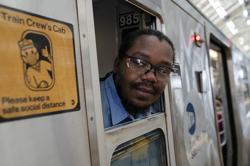 Desmond Hill, a vaccinated MTA conductor, checks the platform for late riders attempting to board the train as he works the N subway line from Brooklyn's Coney Island to Queen's Astoria-Ditmars neighborhoods in New York.

(AP/John Minchillo)