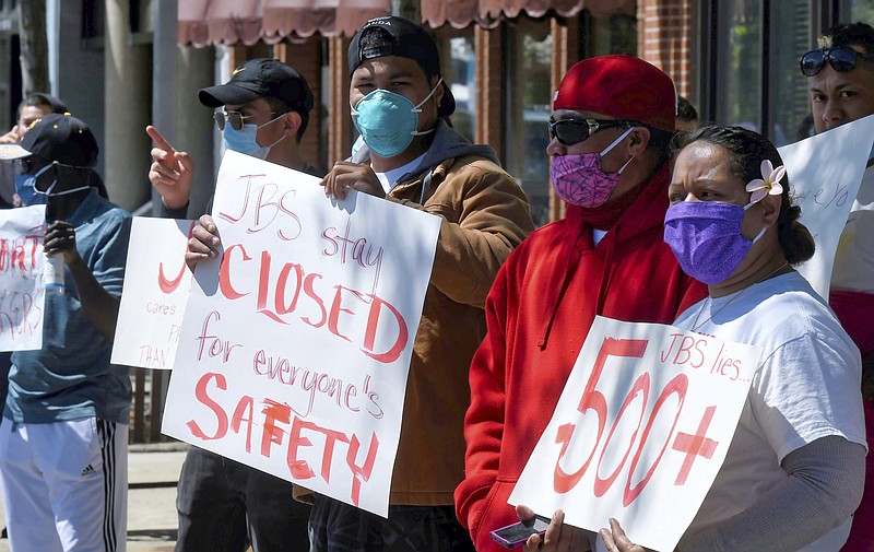 FILE - In this June 9 2020, file photo, JBS workers protest, June 9, 2020, in Logan, Utah, where hundreds of workers at the meatpacking plant in Hyrum, Utah, tested positive for COVID-19. Workers on farms and at meatpacking plants who were severely affected by the coronavirus pandemic will be eligible to get grants of up to $600 per person as part of a new $700 million aid program the U.S. Department of Agriculture announced Tuesday, Sept. 7, 2021. (Eli Lucero/The Herald Journal via AP, File)