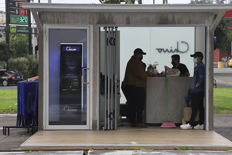 Government employees open the customer service area of a Chivo digital wallet machine, which exchanges cash for Bitcoin cryptocurrency, at Las Americas Square in San Salvador, El Salvador, Tuesday, Sept. 7, 2021. Starting Tuesday, all businesses will have to accept payments in Bitcoin, except those lacking the technology to do so, according to a law approved by the congress. (AP Photo/Salvador Melendez)
