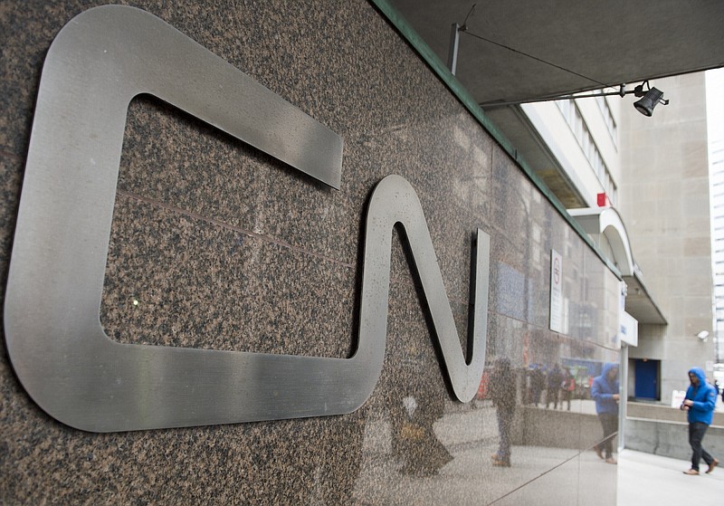 FILE - In this May 13, 2021, file photo, a man walks into Central Station next to Canadian National headquarters in Montreal. Canadian National&#x2019;s $33.6 billion deal to acquire Kansas City Southern railroad is in jeopardy after federal regulators rejected a key part of the plan Tuesday, Aug. 31, 2021 and opened the door for a competing $31 billion offer from Canadian Pacific railroad. (Graham Hughes/The Canadian Press via AP, File)