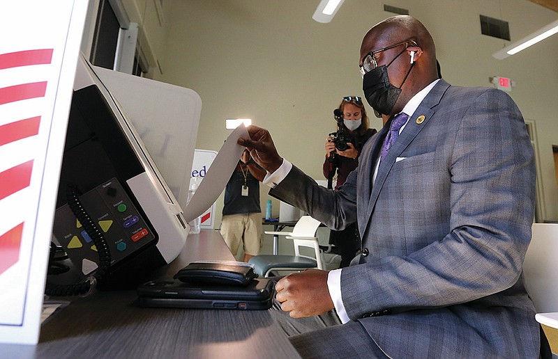 Little Rock Mayor Frank Scott Jr. puts his ballot in the voting machine on Tuesday, Sept. 7, 2021, at the Cowan Library while early voting in the citywide special election for adopting a 1% sales tax in Little Rock. 
(Arkansas Democrat-Gazette/Thomas Metthe)