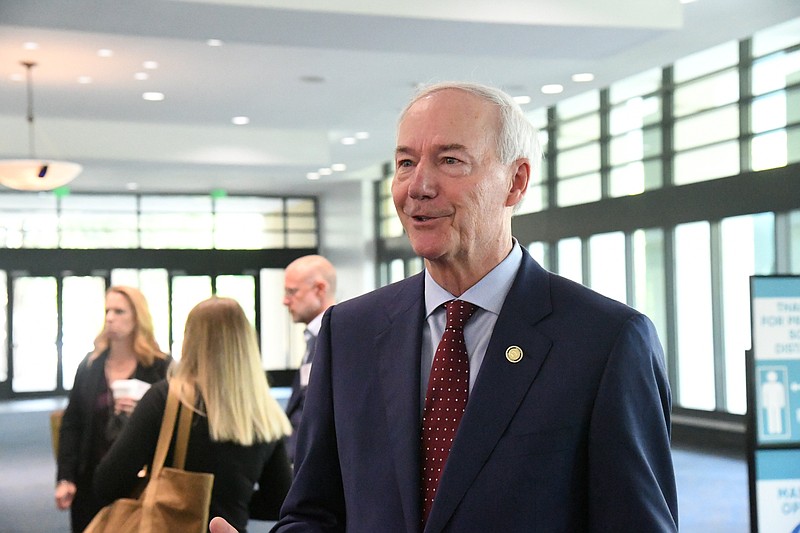 Gov. Asa Hutchinson speaks to the media Wednesday at the Arkansas Connectivity Summit in the lobby of the Hot Springs Convention Center. - Photo by Tanner Newton of The Sentinel-Record