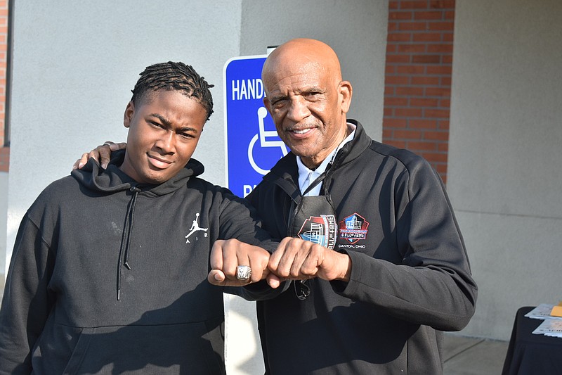 Kalye Gibson, a freshman at Pine Bluff High School, tries on a championship ring from Pro Football Hall of Famer Drew Pearson. (Pine Bluff Commercial/I.C. Murrell)