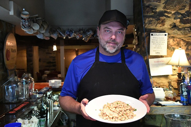 David McGuire, owner of Steinhaus Keller, displays a dish of Chicken Diane. - Photo by Tanner Newton of The Sentinel-Record