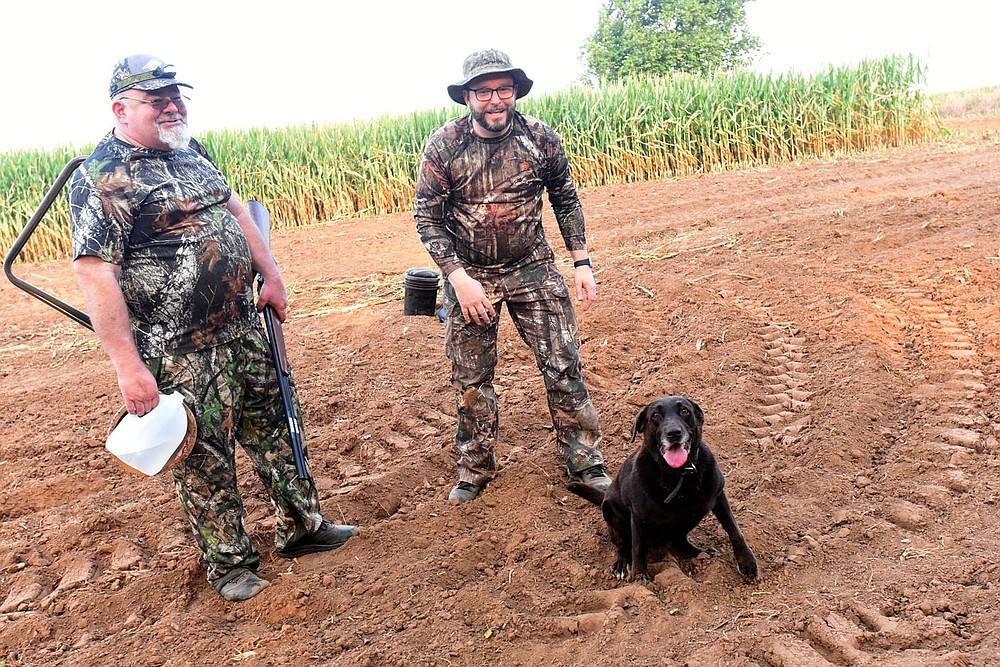 Russell Pardue (left) of Tulsa, Okla. and Craig Pardue of Fayetteville wrap up their opening-morning dove hunt on Sept. 4 2021 near Prairie Grove with their retriever, Brooke.
(NWA Democrat-Gazette/Flip Putthoff?