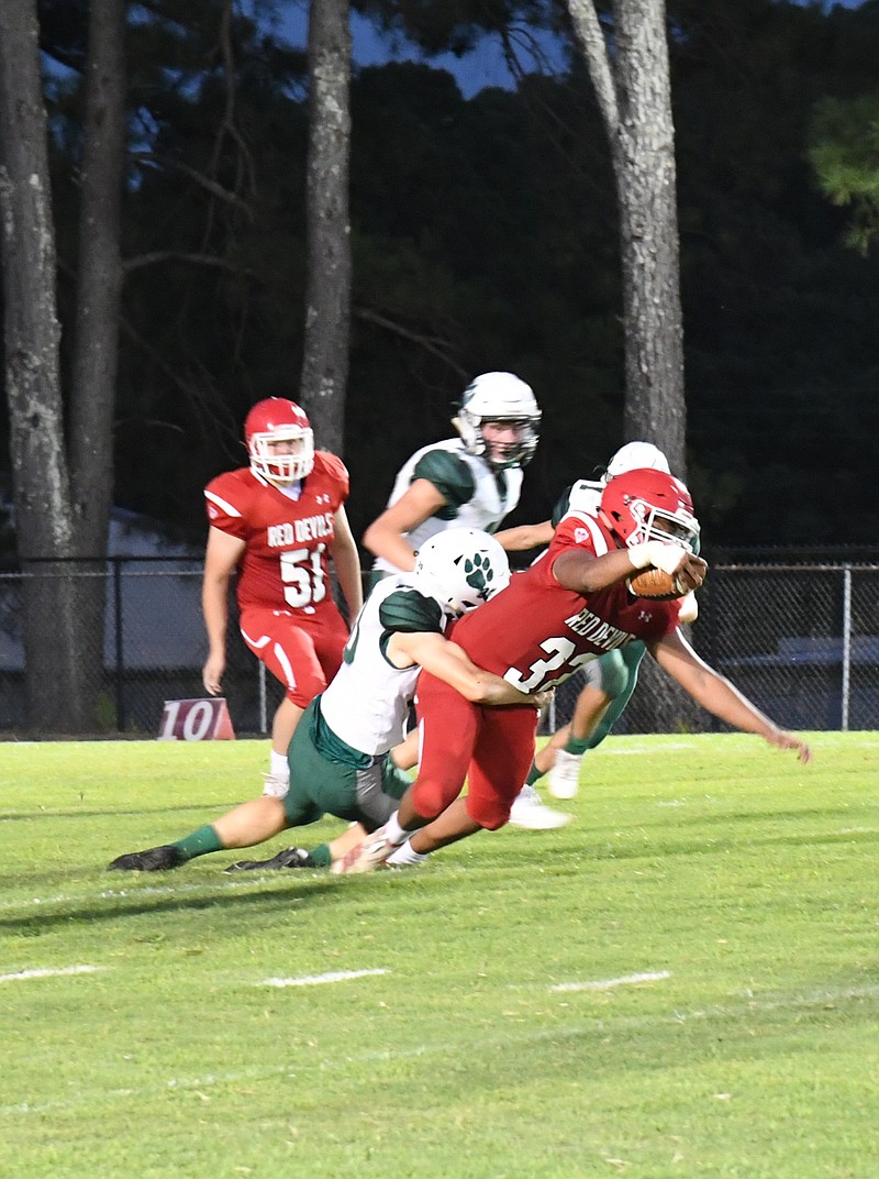 Mountain Pine's Dayjon Matlock (32) is tackled by Episcopal Collegiat's Layne Keck during an Aug. 28 game at Stanley May Field. - Photo by Tanner Newton of The Sentinel-Record