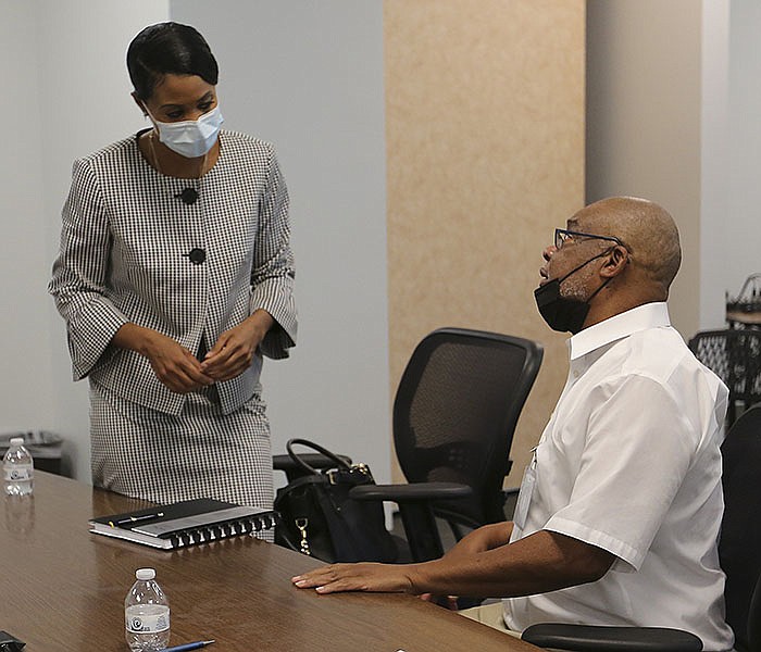 Ericka Benedicto (left) talks with Metropolitan Housing Alliance board member Lee Lindsey following the MHA board meeting on Thursday, Sept. 9, 2021, in Little Rock. Benedicto was named the MHA's new interim executive director during the meeting. 
(Arkansas Democrat-Gazette/Thomas Metthe)