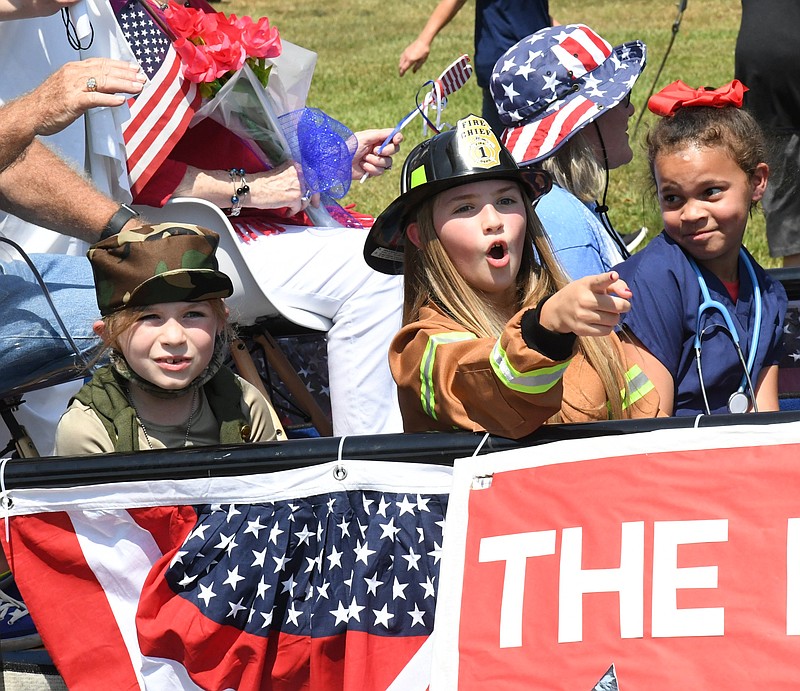 Lake Hamilton students dressed as soldiers, firefighters and doctors ride on a float Friday during the school district's 9.11.01 Remembrance Parade. - Photo by Tanner Newton of The Sentinel-Record
