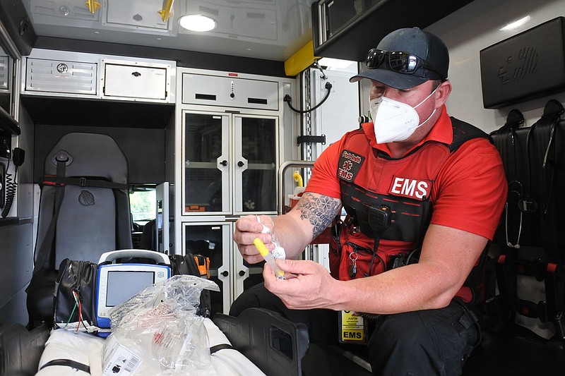 Justin Yauger, paramedic field supervisor for Fort Smith EMS, provides details on a syringe that can be used to nasally administer Narcan in an ambulance at Fort Smith EMS' facility Sept. 13. 
(NWA Democrat-Gazette/Thomas Saccente)