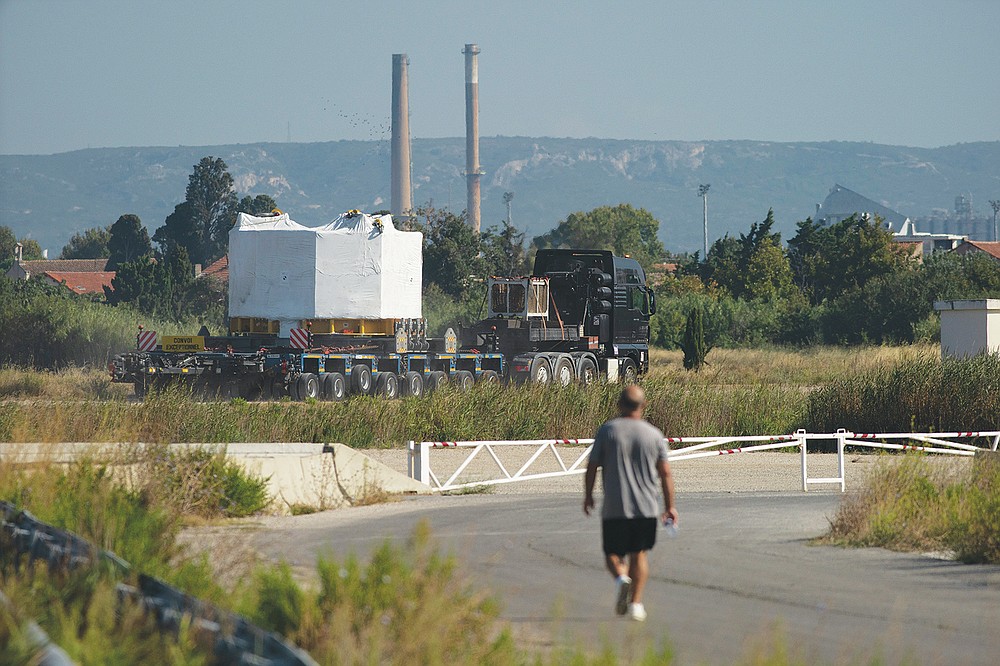 A central solenoid magnet for the ITER project departs from Berre-l'Etang in southern France, Monday, Sept. 6, 2021. The first part of a massive magnet so strong its American manufacturer claims it can lift an aircraft carrier arrived Thursday, Sept. 9, 2021 at a high-security site in southern France, where scientists hope it will help them build a 'sun on earth.' Almost 60-feet tall and 14 feet in diameter when fully assembled, the magnet is a crucial component of the International Thermonuclear Experimental Reactor, or ITER, a 35-nation effort to develop an abundant and safe source of nuclear energy for future generations. (AP Photo/Daniel Cole)