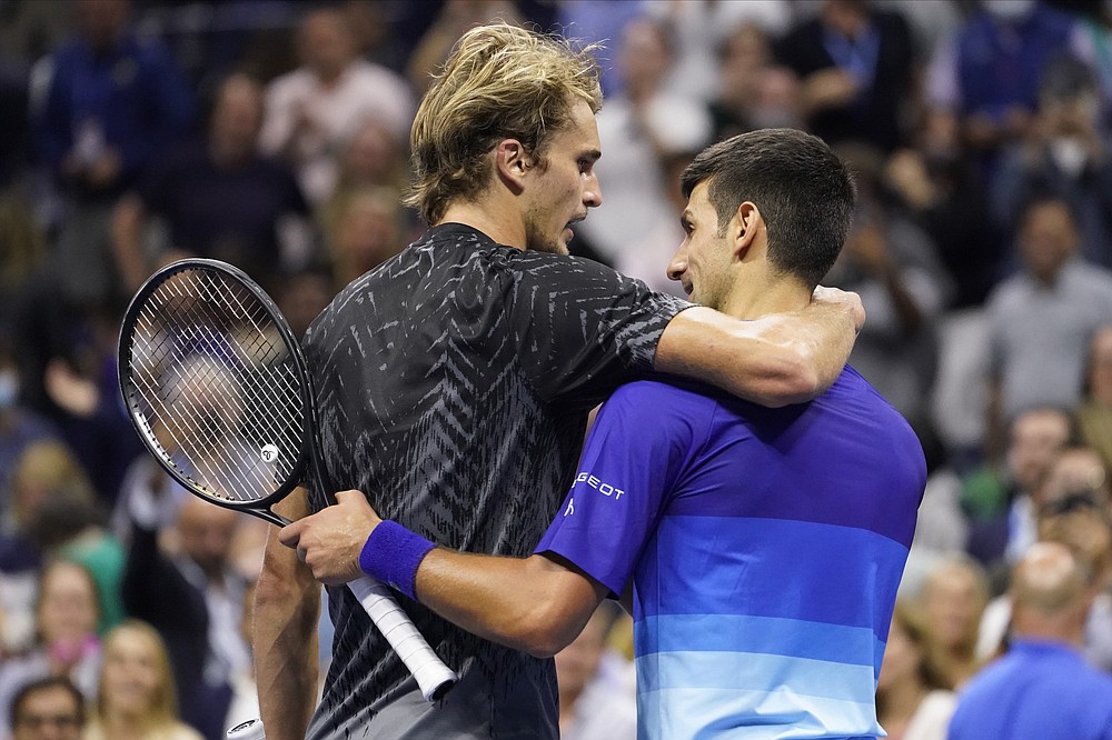 Novak Djokovic, of Serbia, right and Alexander Zverev, of Germany, embrace after Djokovic won their semifinal match of the US Open tennis championships, Friday, Sept. 10, 2021, in New York. (AP Photo/John Minchillo)