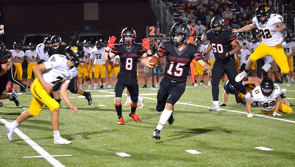 ANNETTE BEARD PEA RIDGE TIMES/Prairie Grove Tigers converge on the Blackhawk quarterback Gavin Dixon (No. 15) Friday night in Blackhawk Stadium.
