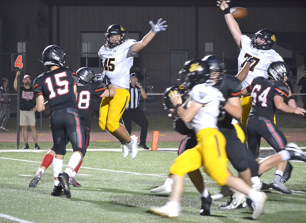 ANNETTE BEARD PEA RIDGE TIMES/Prairie Grove defensive lineman, Matthew Velasco (Tigers No. 45) and Ryder Orr (Tigers No. 77) attempt to block a pass from Blackhawk quarterback Gavin Dixon (No. 15) for the 2-point conversion Friday night in Blackhawk Stadium. Pea Ridge scored 16 points in the fourth, but couldn't overtake Prairie Grove with the Tigers winning 41-28.