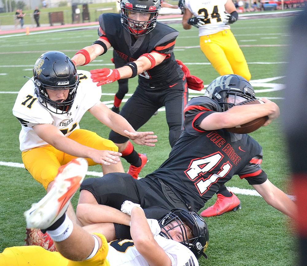 ANNETTE BEARD PEA RIDGE TIMES/Prairie Grove junior Colin Faulk (No. 20) brought down Pea Ridge Blackhawk Bowen Phillips (No. 41) on Friday, Sept. 10, 2021. Prairie Grove won 41-28 to even its season record at 1-1.