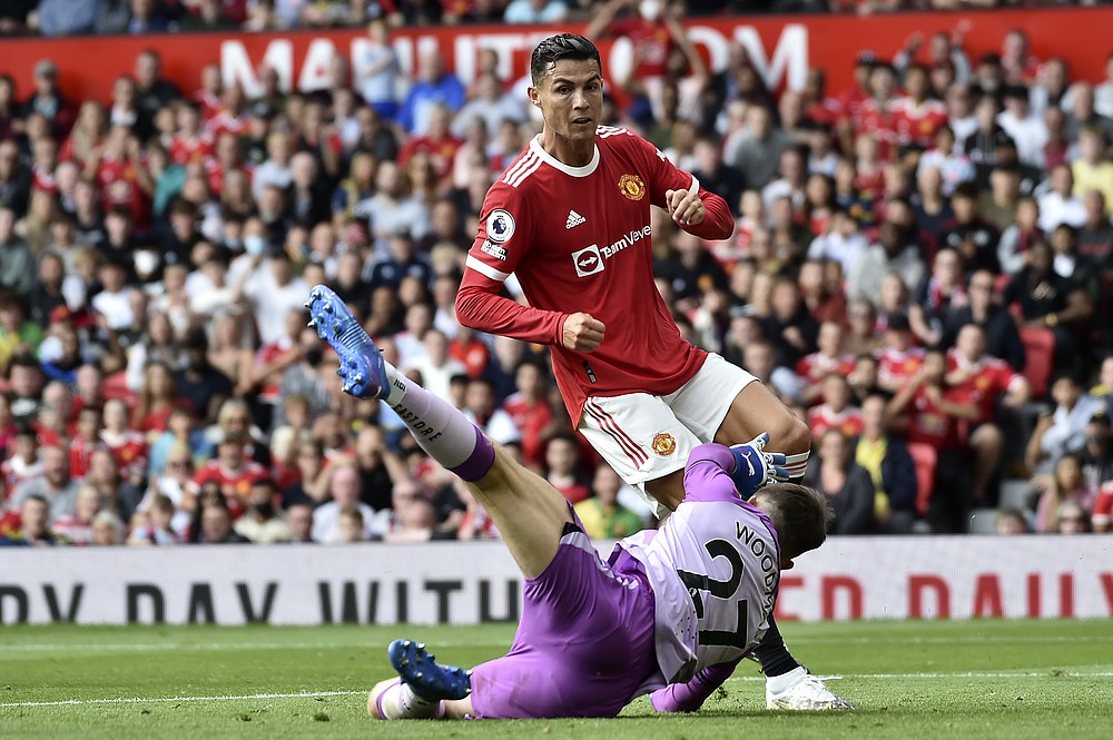 Newcastle's goalkeeper Freddie Woodman fails to stop Manchester United's Cristiano Ronaldo scoring the opening goal during the English Premier League soccer match between Manchester United and Newcastle United at Old Trafford stadium in Manchester, England, Saturday, Sept. 11, 2021. (AP Photo/Rui Vieira)