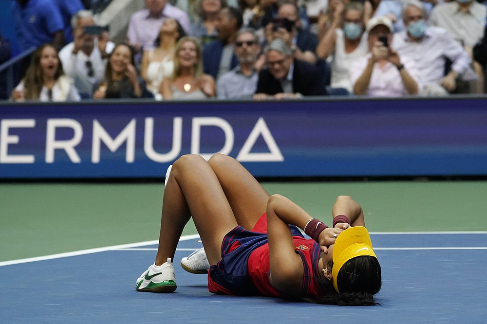 Emma Raducanu, of Britain, lies on the court after defeating Leylah Fernandez, of Canada, during the women's singles final of the US Open tennis championships, Saturday, Sept. 11, 2021, in New York. (AP Photo/Elise Amendola)