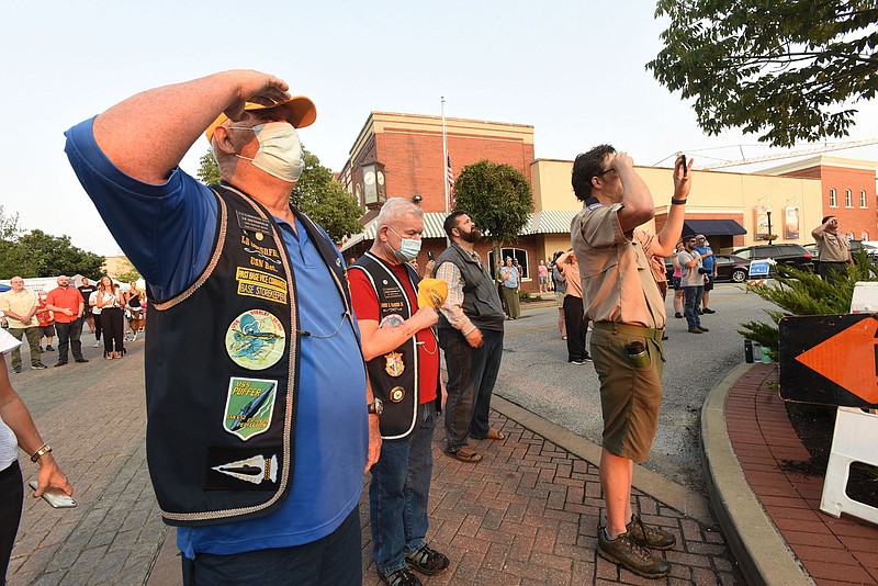 Le Osterfeld (cq) with the USS Snook Base submarine veterans group based in Rogers salutes on Saturday Sept. 11 2021 during the Pledge of Allegiance at the 9-11 remembrance ceremony in Bentonville. Go to nwaonline.com/210912Daily/ to see more photos.
(NWA Democrat-Gazette/Flip Putthoff)