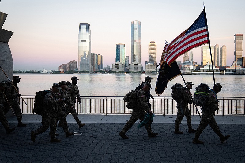 Members of the National Guard walk during the 9/11 mile march in commemoration of the 20th anniversary of the Sept. 11, 2001 terrorist attacks in New York, Saturday, Sept. 11, 2021. (Gabriela Bhaskar/The New York Times)