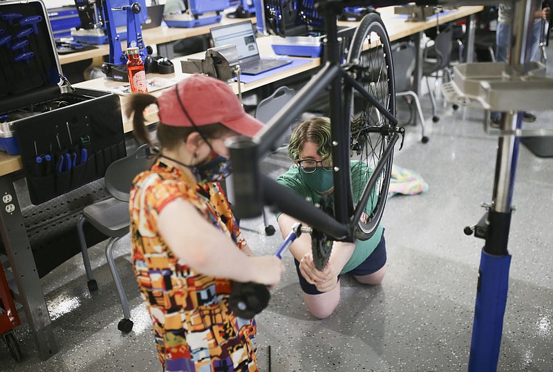 Gentry Dillinger (from left) and Dilynn Swearengin assemble a bike, Thursday, September 9, 2021 at the Northwest Arkansas Community College in Bentonville. The Northwest Arkansas Community College Workforce &amp; Economic Development Division held an open house Aug. 20 for its new Bicycle Technician Lab. In April, the college was awarded a $1,246,864 grant from the Walton Family Charitable Support Foundation. Funding is being used for the phased roll-out of the college's new Bicycle Assembly and Repair Technician program. Check out nwaonline.com/210910Daily/ for today's photo gallery. 
(NWA Democrat-Gazette/Charlie Kaijo)