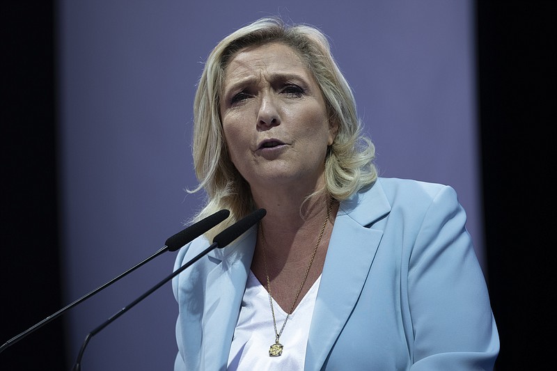 Marine Le Pen gestures delivers a speech, at a National Rally event in Frejus, France, Sunday, Sept. 12, 2021. Two politicians have formally declared their intentions to seek to become France&#x2019;s first female president in next year&#x2019;s spring election. National Rally&#x2019;s Marine Le Pen and Paris&#x2019; Socialist mayor, Anne Hidalgo, both officially launched their campaigns Sunday in what were widely expected moves. (AP Photo/Daniel Cole)