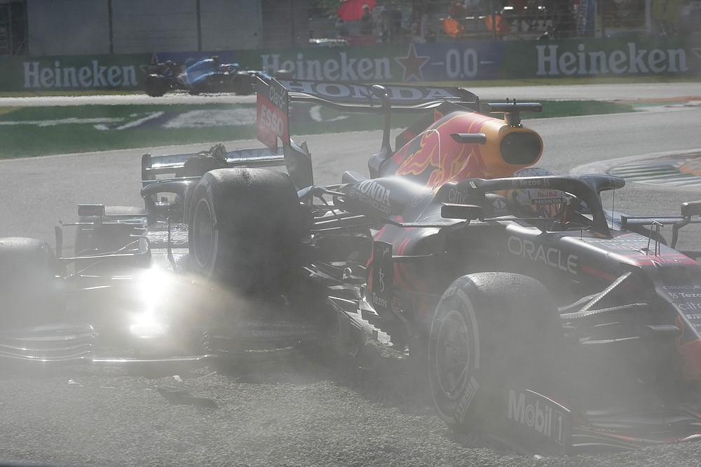 Red Bull driver Max Verstappen of the Netherlands, right and Mercedes driver Lewis Hamilton of Britain crash during the Italian Formula One Grand Prix, at Monza racetrack, in Monza, Italy, Sunday, Sept.12, 2021. (AP Photo/Luca Bruno)