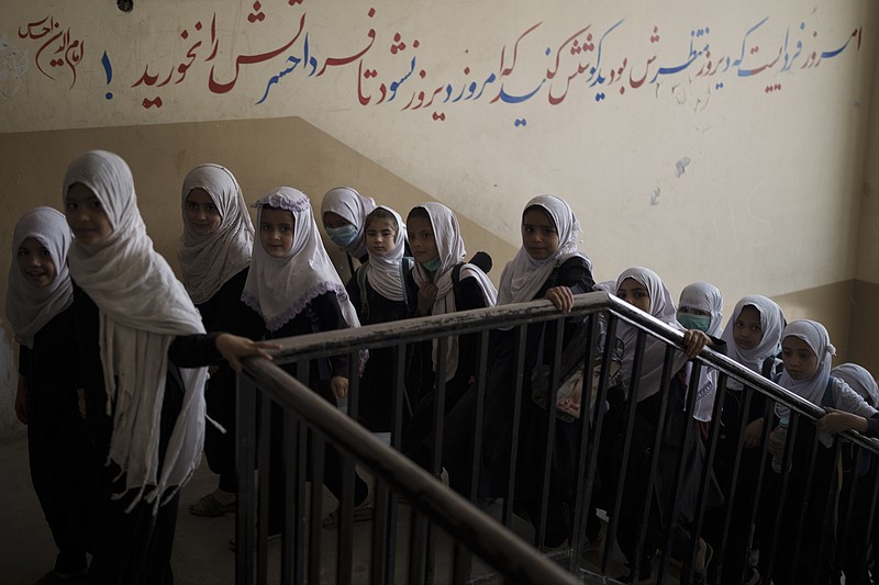 Girls walk upstairs as they enter a school before class Sunday in Kabul, Afghanistan. - AP Photo/Felipe Dana