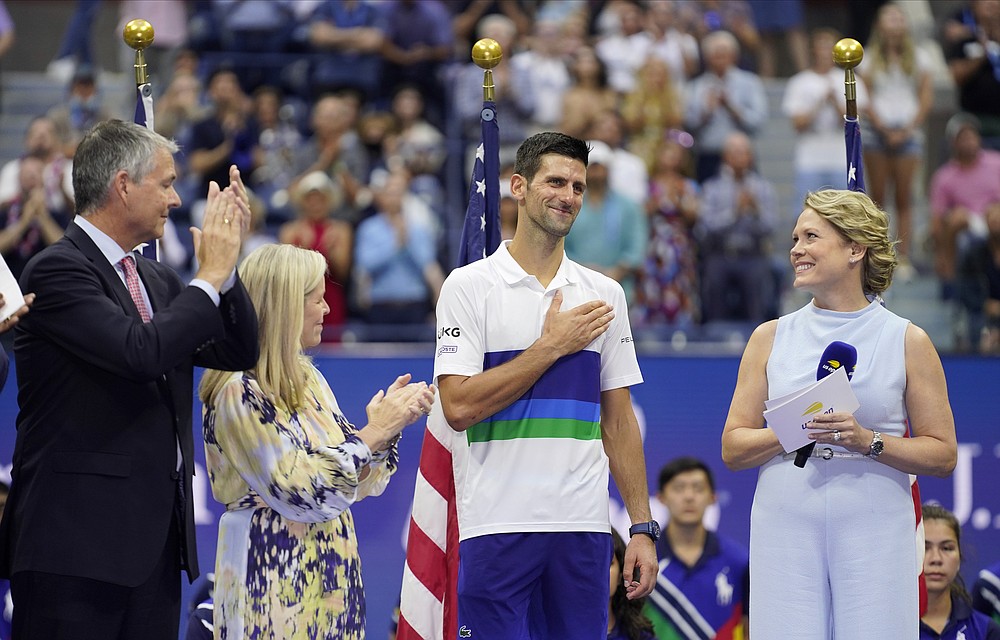Novak Djokovic, of Serbia, center, reacts while talking to fans after losing to Daniil Medvedev, of Russia, in the men's singles final of the US Open tennis championships, Sunday, Sept. 12, 2021, in New York. (AP Photo/John Minchillo)