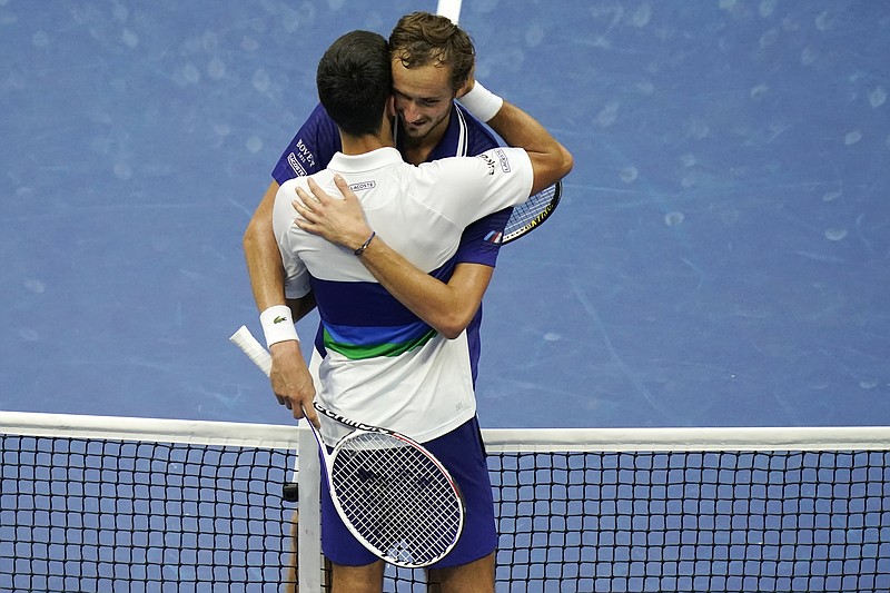 Daniil Medvedev, of Russia, right, hugs Novak Djokovic, of Serbia, after defeating Djokovic during the men's singles final of the US Open tennis championships, Sunday, Sept. 12, 2021, in New York. (AP Photo/Seth Wenig)