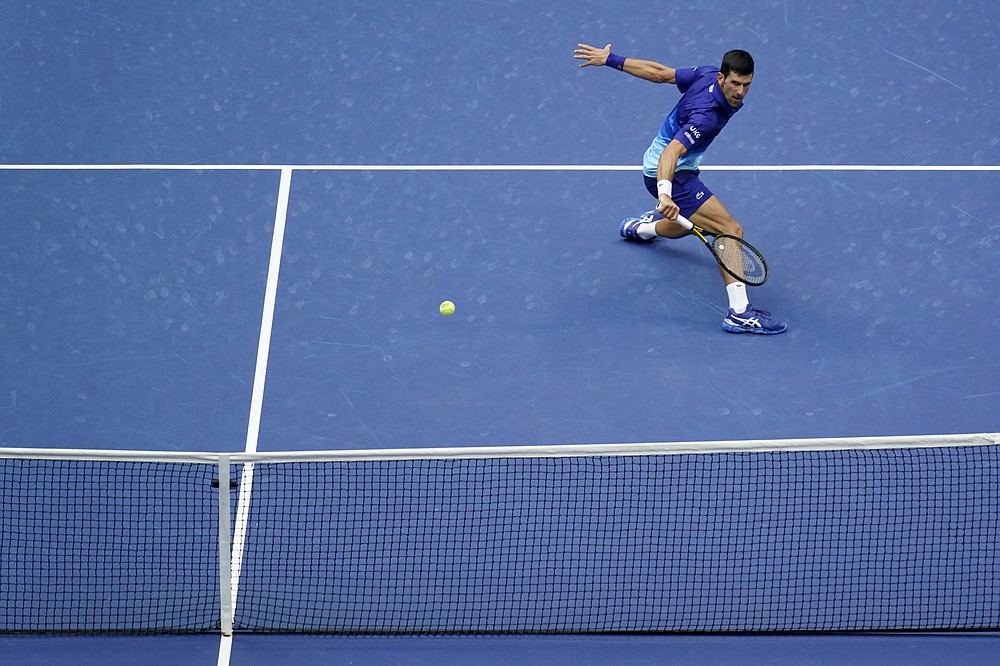 Novak Djokovic, of Serbia, returns a shot to Daniil Medvedev, of Russia, during the men's singles final of the US Open tennis championships, Sunday, Sept. 12, 2021, in New York. (AP Photo/Seth Wenig)