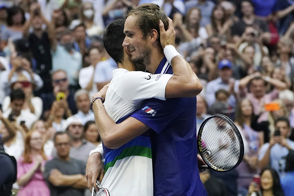 Daniil Medvedev, of Russia, hugs Novak Djokovic, of Serbia, after defeating Djokovic in the men's singles final of the US Open tennis championships, Sunday, Sept. 12, 2021, in New York. (AP Photo/Elise Amendola)