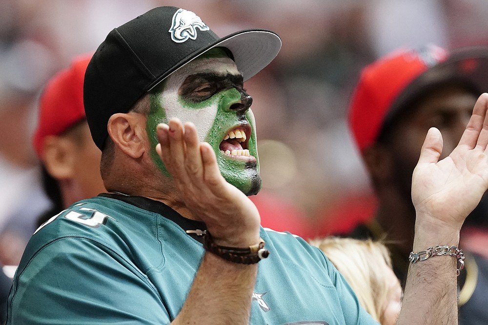 A Philadelphia Eagles fan cheers during the first half of an NFL football game against the Atlanta Falcons, Sunday, Sept. 12, 2021, in Atlanta. (AP Photo/John Bazemore)