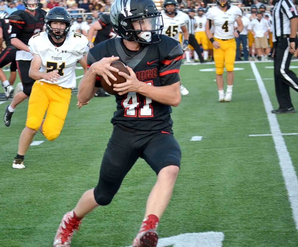 Sophomore Bowen Phillips, No. 41, evades Tigers as he scurries down the field Friday, Sept. 10, 2021.