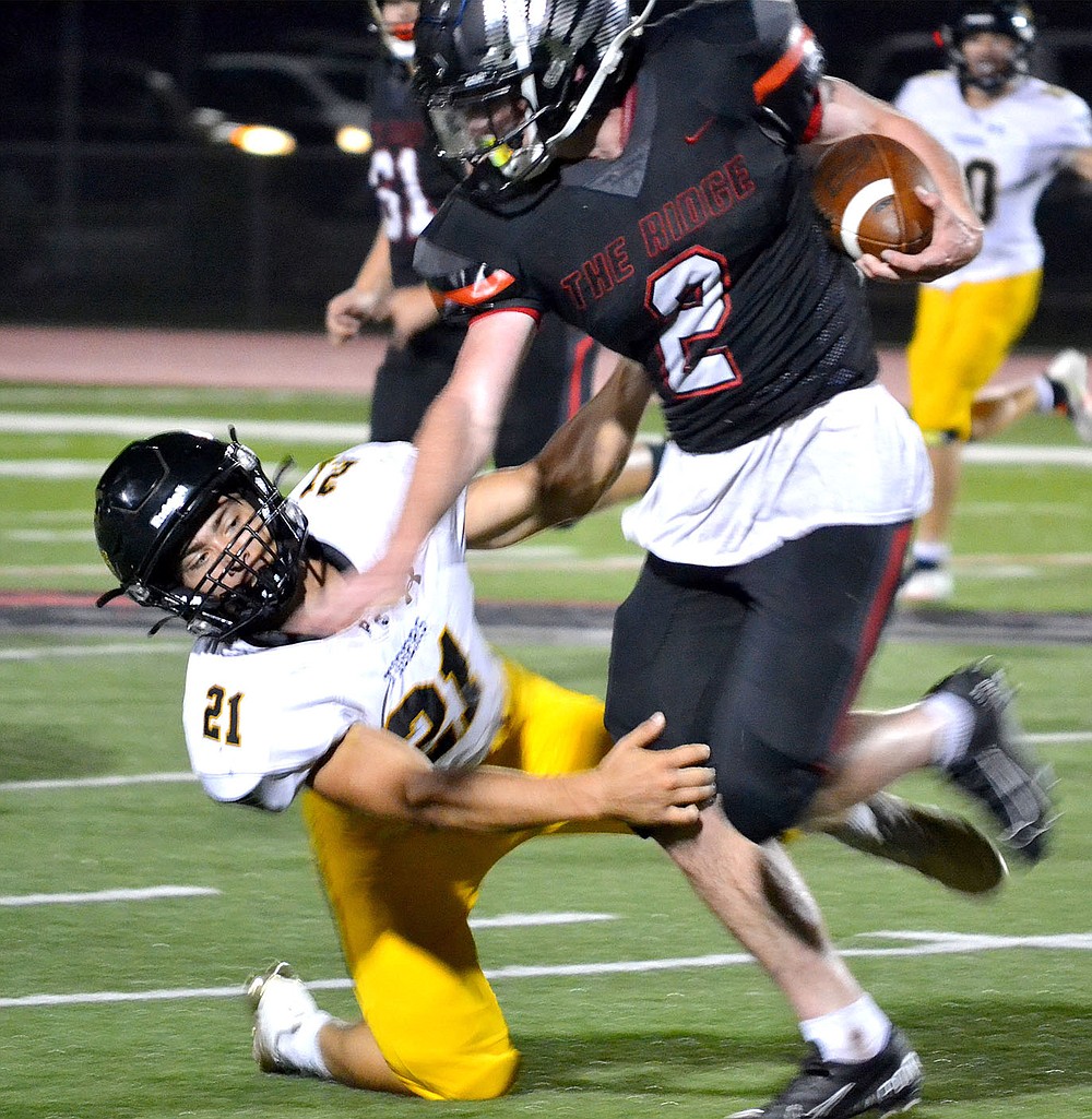 Senior running back Joe Adams evades a tackle and continues down the field Friday, Sept. 10, 2021.