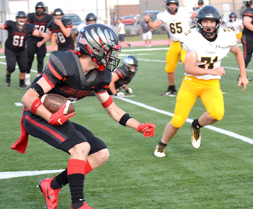 Senior wide receiver Trevor Blair, No. 8, maneuvers to avoid a tackle Friday, Sept. 10, 2021, when the Blackhawks hosted the Prairie Grove Tigers.
