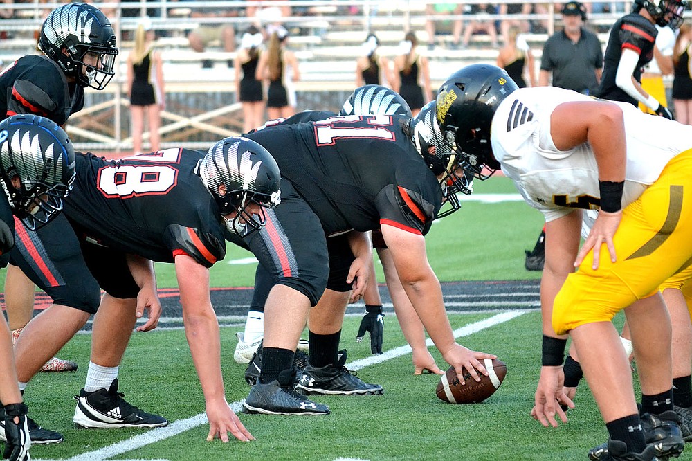 Blackhawk offensive line men junior Connor Pierce, No. 61, and freshman Peyton Carney, No. 78, line up against the Prairie Grove Tigers defensive line Friday, Sept. 10, 2021.