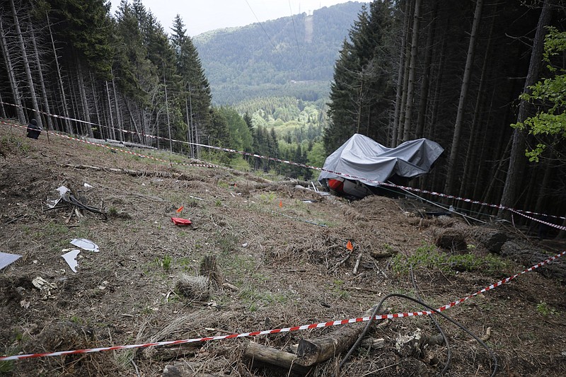 FILE - In this May 26, 2021 file photo, the wreckage of a cable car after it collapsed near the summit of the Stresa-Mottarone line in the Piedmont region, northern Italy. A six-year-old boy who was the sole survivor of a cable car crash this year in northern Italy is at the center of a bitter custody battle between his maternal grandparents in Israel and his paternal relatives in Italy, who claim the child was flown without their permission to Israel over the weekend. (AP Photo/Luca Bruno)