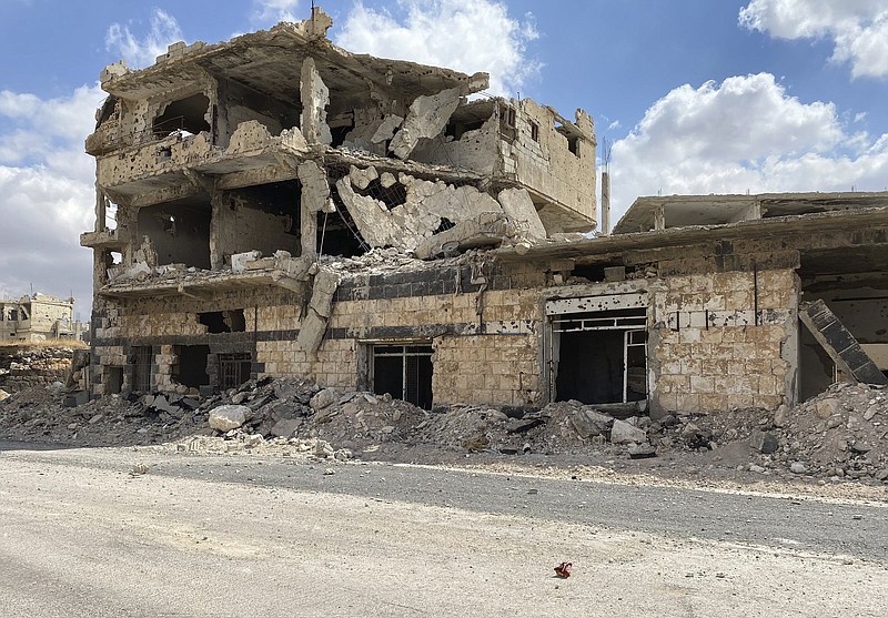 A building damaged by Syrian government forces following clashes with rebel fighters is seen in the southern city of Daraa, Syria, Sunday, Sept 12, 2021. A Russian-negotiated deal went into effect last week to end a government siege and intense fighting in the city of Daraa and with rebel fighters holed up Daraa al-Balad forcing some of them to go to the rebel-held north and others to surrender their weapons in return for amnesty. (AP Photo)