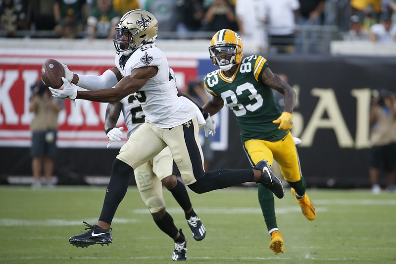 New Orleans Saints free safety Marcus Williams, left, intercepts a pass in front of Green Bay Packers wide receiver Marquez Valdes-Scantling (83) during the second half of Sunday's NFL game in Jacksonville, Fla. - Photo by Stephen B. Morton of The Associated Press