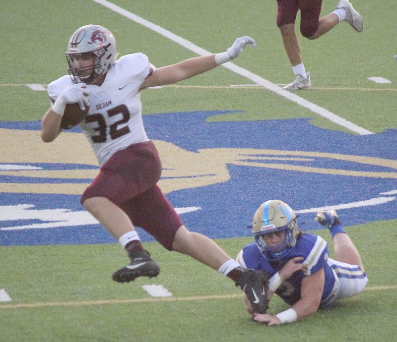 Julie Chandler/Special to the Herald-Leader
Siloam Springs senior Brendan Lashley tries to slip the tackle attempt of Harrison's Beck Jones during last Friday's game in Harrison.