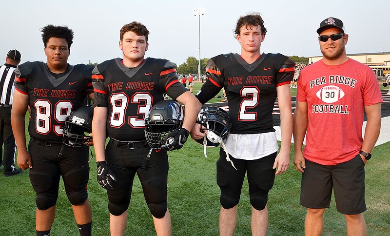 Blackhawk captains No. 89 Devon Hopkins, No. 83 Justin Blount and No. 2 Joe Adams were joined Friday night by honorary captain Joey Wiltgen, a former Blackhawk All State running back and linebacker.