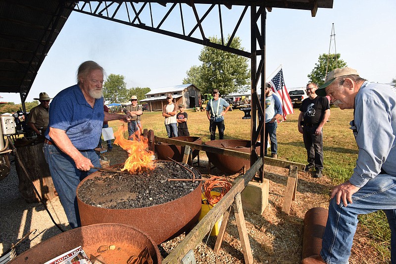 Gary Mulkey of Branson, Mo. gives a blacksmithing demonstration on Saturday Sept. 11 2021 during the Tired Iron of the Ozarks tractor and antique show near Gentry. The show featured all kinds of tractors, farm machinery, antique engines, tools and blacksmithing demonstrations. 
(NWA Democrat-Gazette/Flip Putthoff)